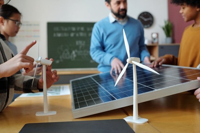 Estudiantes de energías renovables en una clase mirando paneles solares