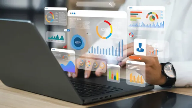 an analyst uses a laptop with a digital overlay showing various data visualisations, including colorful bar charts, line graphs and donut charts