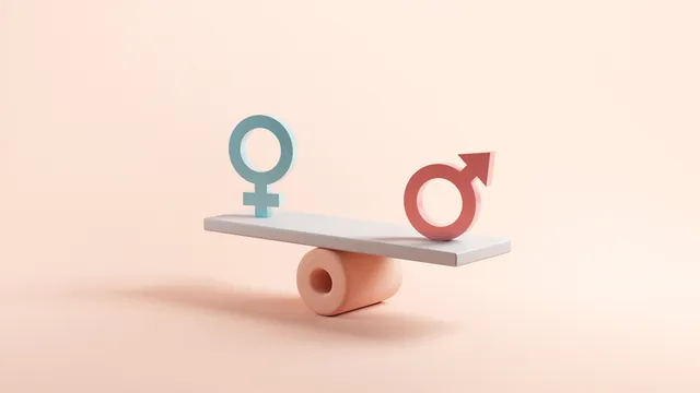 símbolos masculino y femenino sobre una balanza