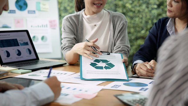 persona mostrando una carpeta con un documento de sostenibilidad, reciclaje y medioambiente