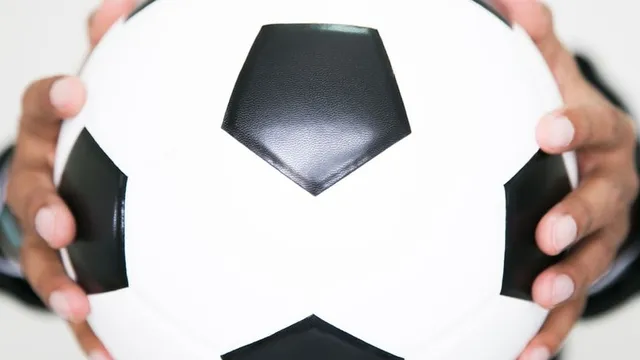 imagen de una manager de fútbol sosteniendo un balón