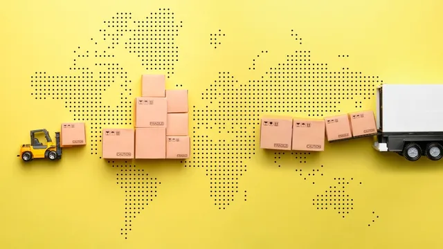 Un cargador carga mercancías en un camión contra el fondo de un mapa mundial