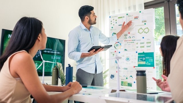 equipo de trabajo presentando un informe sobre sostenibilidad empresarial